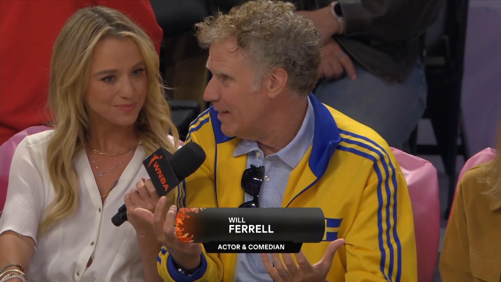 Nikki Kay interviewing actor and comedian Will Ferrell at a WNBA game